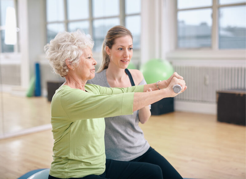 old woman with personal trainer