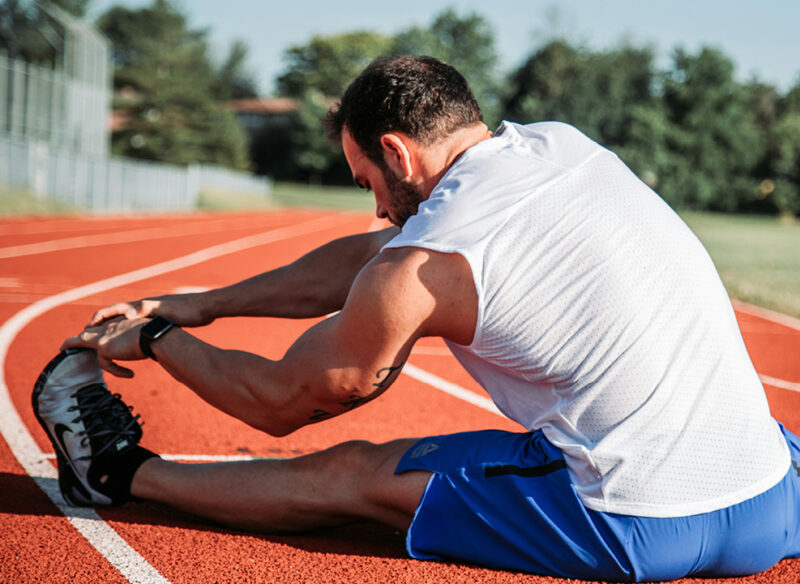 man stretching on a field
