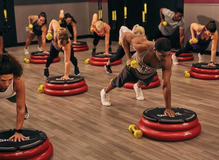 people in dumbbell hiit class