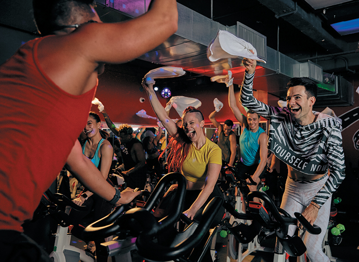 people on a stationary bike in a ride class