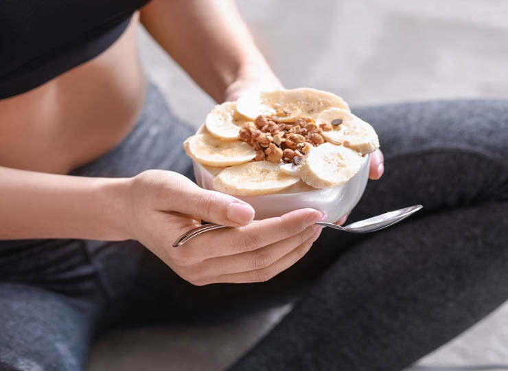 person eating a breakfast bowl